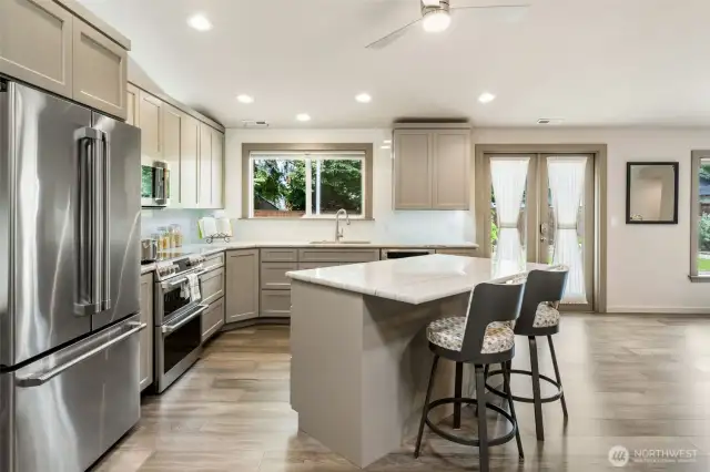 French doors open directly to the backyard patio, creating a seamless flow between indoor and outdoor spaces—ideal for entertaining. With the kitchen perfectly positioned nearby, hosting gatherings becomes effortless and inviting.