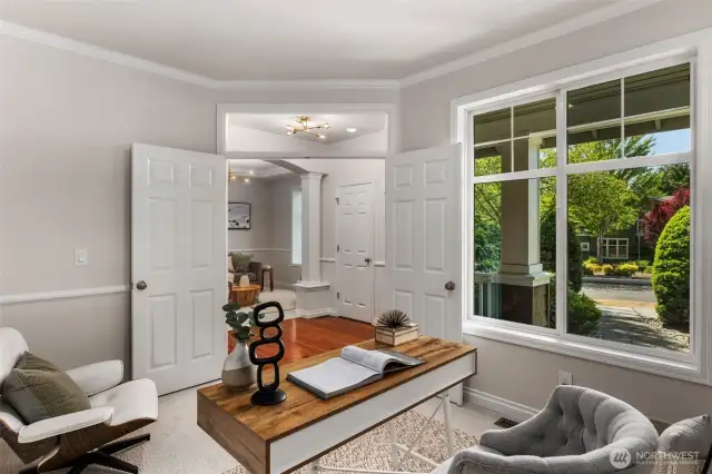 Just off the foyer, the den features classic French doors, a large front-facing window, and elegant chair rail detailing—making it an ideal spot for a home office with, if desired, the perfect setup to welcome clients. This flexible space also works beautifully as a reading room, study, or creative retreat.