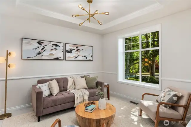 Graceful columns and a tray ceiling define this formal dining room, accented by a stylish new chandelier and timeless trim details. The room connects to the kitchen through a convenient butler’s pantry and also functions beautifully as a welcoming front parlor or sitting room.
