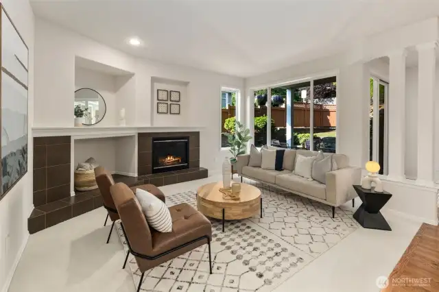 Step into the cozy living room, with its large backyard-facing window, soft new carpeting, and built-in recessed niches ideal for a TV or entertainment system.