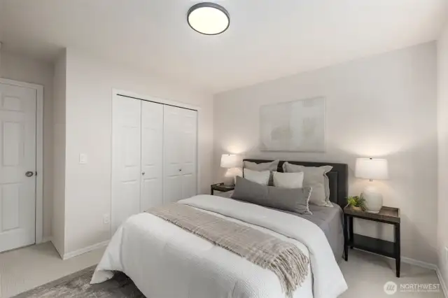 Crisp white walls and new carpet make this peaceful second guest bedroom a restful retreat. A spacious double-door closet and the new overhead light fixture adds a fresh, modern finish.