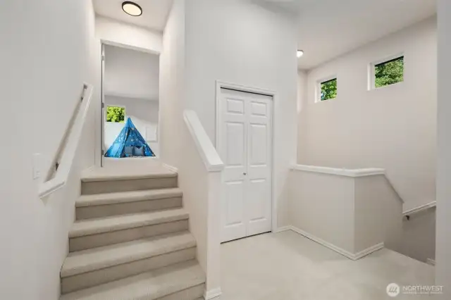 Tucked just a few steps above the main hallway, the fourth bedroom enjoys a quiet sense of privacy. Freshly carpeted and filled with soft natural light from nearby clerestory windows, this upper landing creates a gentle transition into the secluded space beyond.