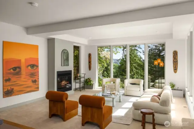 Large living room next to the formal dinning room with stunning views of NW nature.