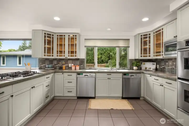 Kitchen with 2 washing machines (Bosch) , integrated double oven, gas cooktop (Bosch), telescopic downdraft with remote blower, integrated microwave oven, fridge with ice/water dispenser, additional beverage refrigerator.