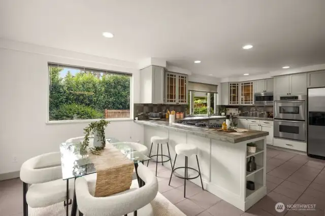 Eating space in kitchen with doors to the deck shared with the formal dining room.