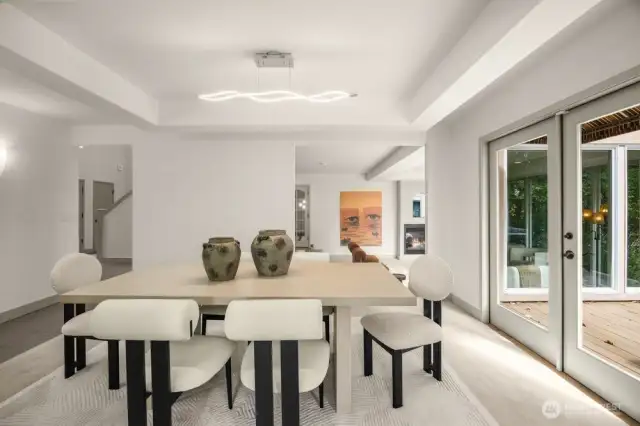 Formal dinning room with doors to the large deck, which is shared with the kitchen with eating space. (1 of 3 decks)