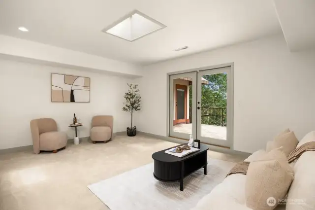 Another common area / living room at the top of the stairs. This room has access to the 3 deck shared with the primary bedroom. A sub-panel for a hot tub is installed on the deck.