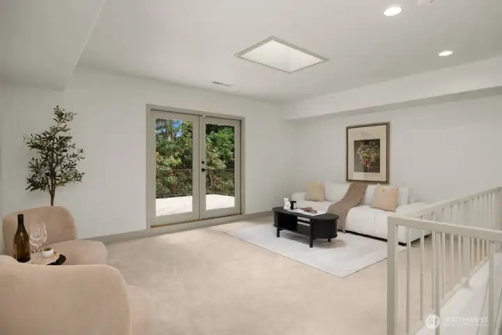 Another common area / living room at the top of the stairs. This room has access to the 3 deck shared with the primary bedroom. A sub-panel for a hot tub is installed on the deck.