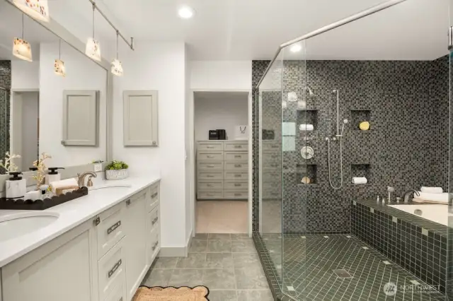 Primary suite bathroom with walk-in closet on the other side.