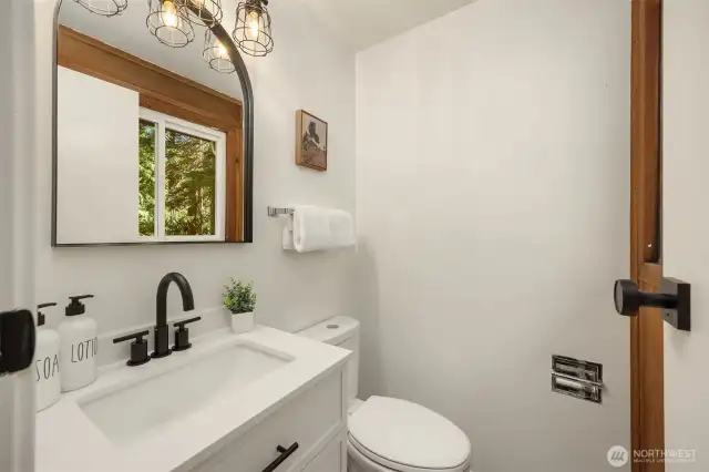 Freshly updated powder room off of the flex space