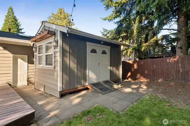 The 10x16 sqft workshop/shed includes power, benches and cabinets!