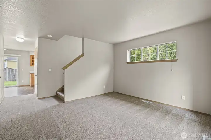 Living room on main level, looking towards kitchen.