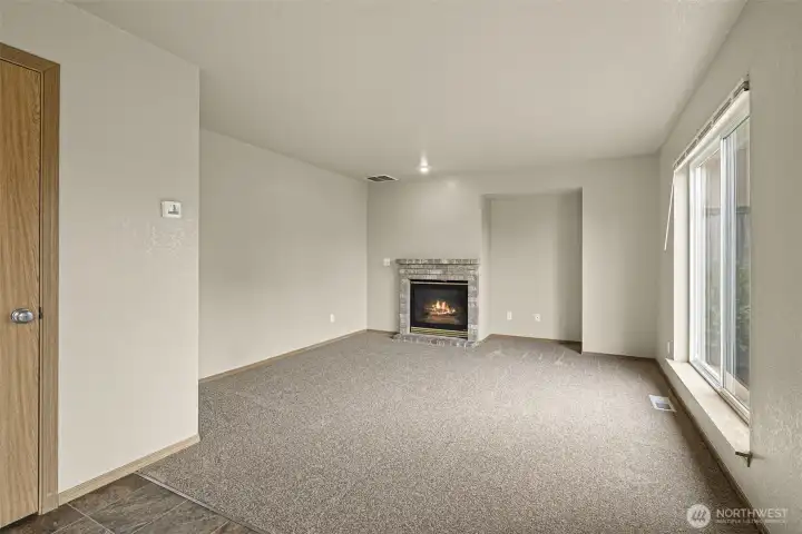 Family room off Kitchen/dining room area, with cozy gas fireplace