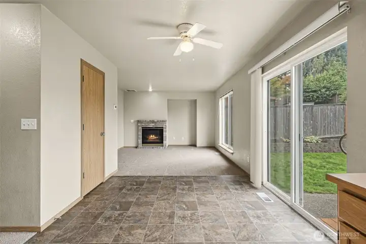 Looking back to family room from kitchen, large slider door to back yard off dining room