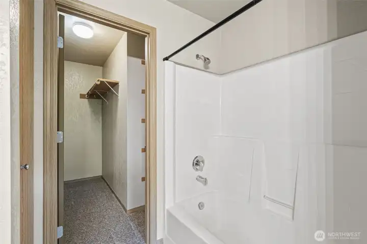Primary bath leading to spacious walk-in closet