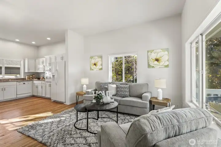 Beautiful great room living area, including vaulted ceilings, white painted millwork, and newly refinished hardwoods.