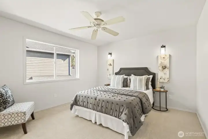 Spacious primary bedroom has an en suite bathroom and walk-in closet.