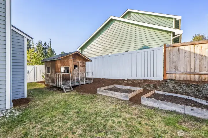 Raised beds plus an adorable play house.