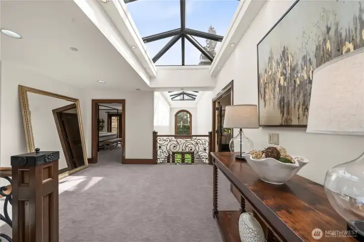 A dramatic linear skylight spanning the length of the home, complete with integrated shading that filters soft natural light throughout.