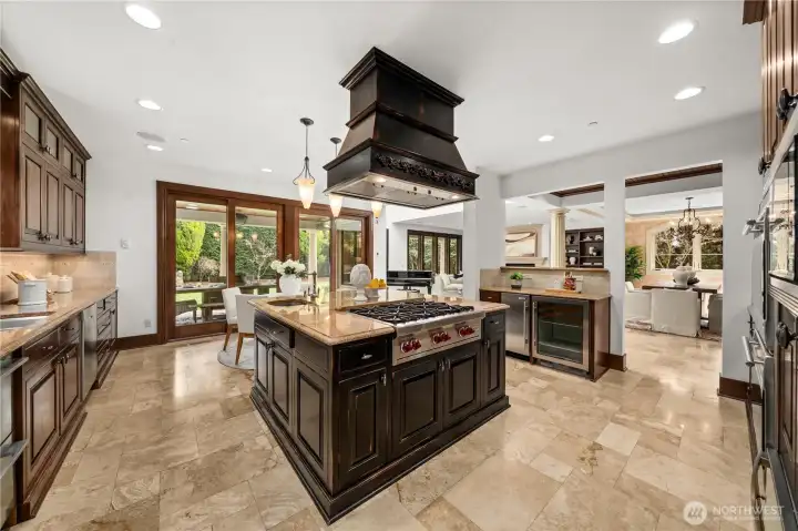 Chef’s kitchen with oversized island, premium appliances, and seamless connection to dining and living spaces.