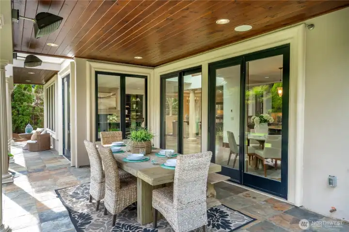 Covered outdoor entertaining area with dining space, creating a seamless indoor-outdoor living experience