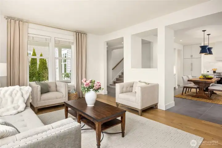 From this angle, one can see the kitchen/dining area to the right, the stairs leading either upstairs (or down) to the left and the hallway leading to the den/office and powder room just inside the entry.