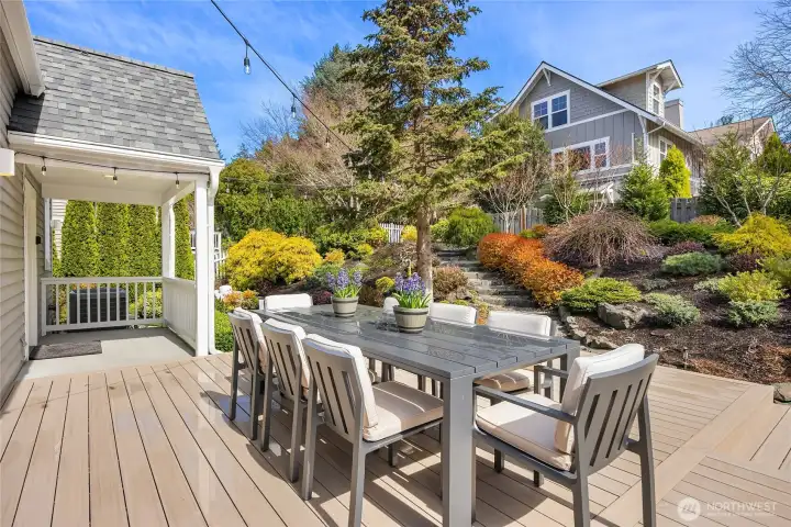 Above the outside dining deck are steps leading to an upper level garden area.