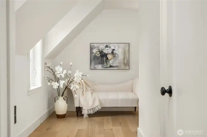 A sweet dressing room in the Primary Suite with adjacent walk-in closet and bath to the right.