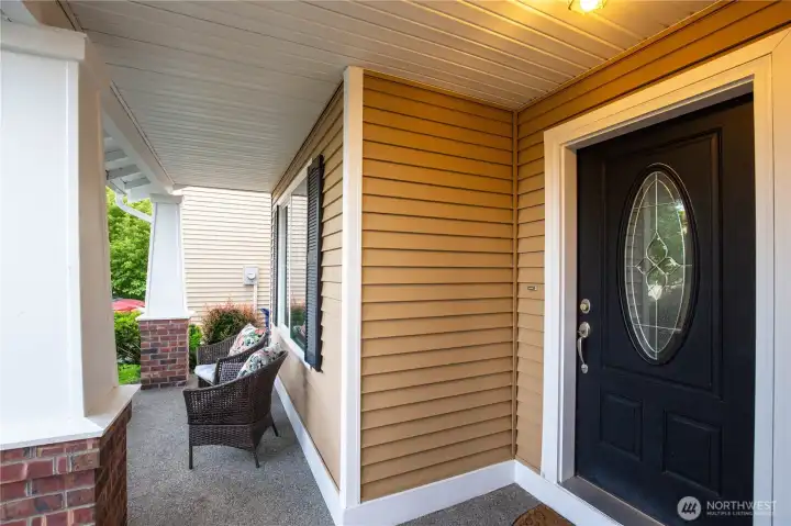 Lovely front porch greets you at the front of the house and front door.