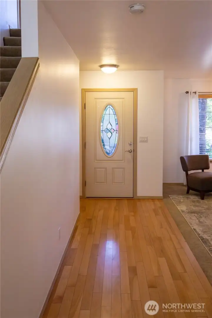 The front entrance to the home is light and bright with beautiful hardwood floors on the main level.