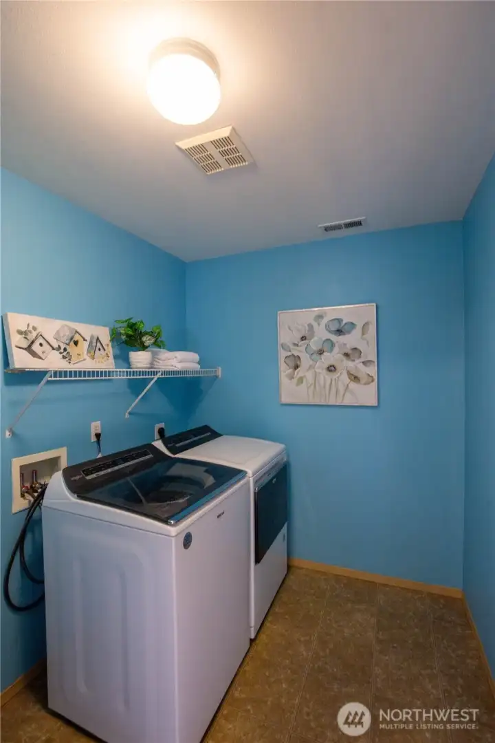 The laundry room is on the main floor and offers space for storage as well.  Newer washer and dryer stay with the home.