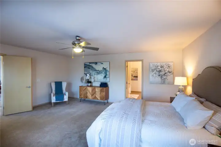 So much space in this primary ensuite with ceiling fan and room for a sitting area.
