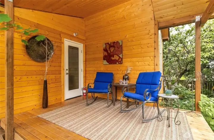 This covered porch on the large cottage is like a dream haven surrounded by beauty This covered porch on the large cottage is like a dream haven surrounded by beauty