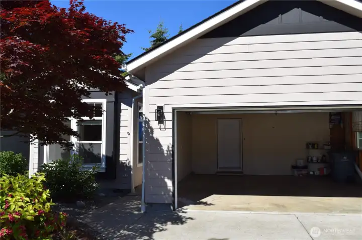 Attached Garage with 2 Doors. Home and Side Yard