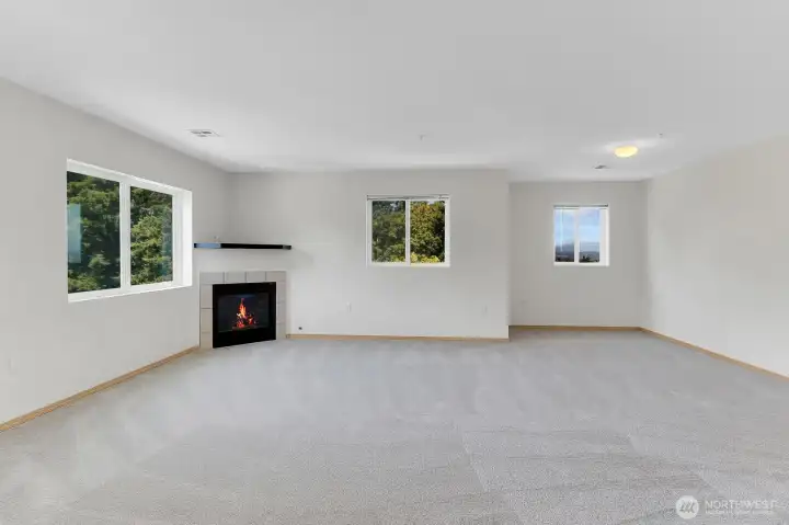 The inviting living room features a corner gas fireplace and an alcove window showcasing mountain views. The inviting living room features a corner gas fireplace and an alcove window showcasing mountain views.
