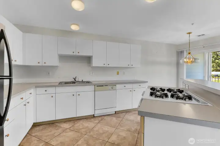 Enjoy a roomy kitchen with ample cabinetry and lots of countertop workspace. Enjoy a roomy kitchen with ample cabinetry and lots of countertop workspace.