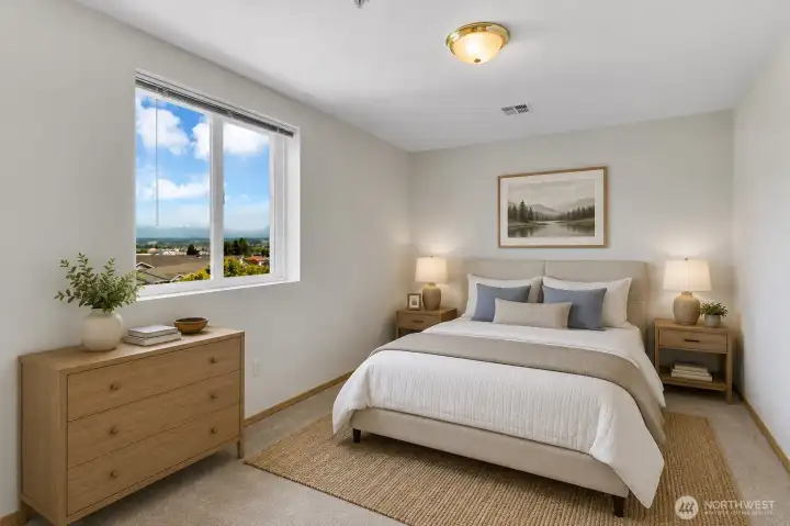 The spacious primary bedroom enjoys picturesque mountain views. *Virtually staged* The spacious primary bedroom enjoys picturesque mountain views. *Virtually staged*