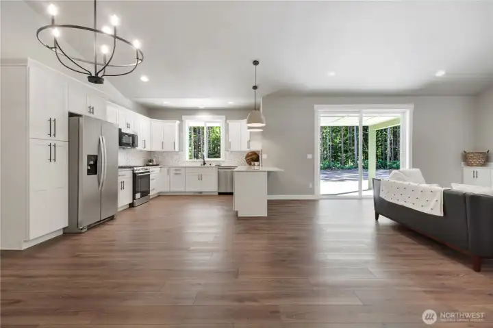 Grand vaulted ceiling entry way with open concpet kitchen with
