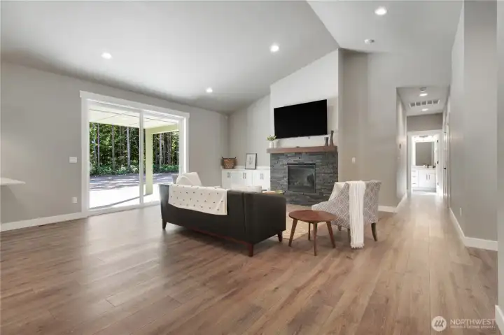 Spacious living area with propane fireplace, mantle and access to the back yard and back patio!