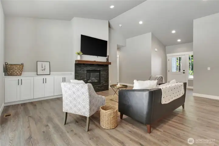 Cozy living area with storage and tv readily mounted for a easy move in