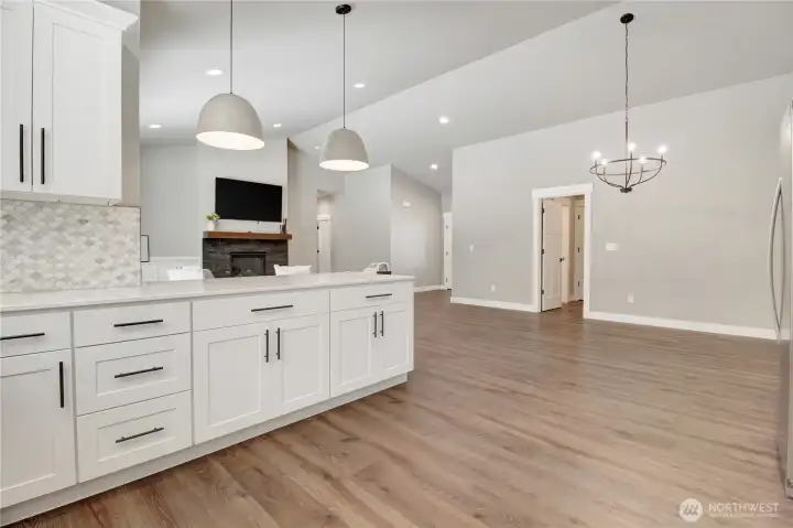 Looking out through the kitchen is the utility room leading to the garage space and half bath.