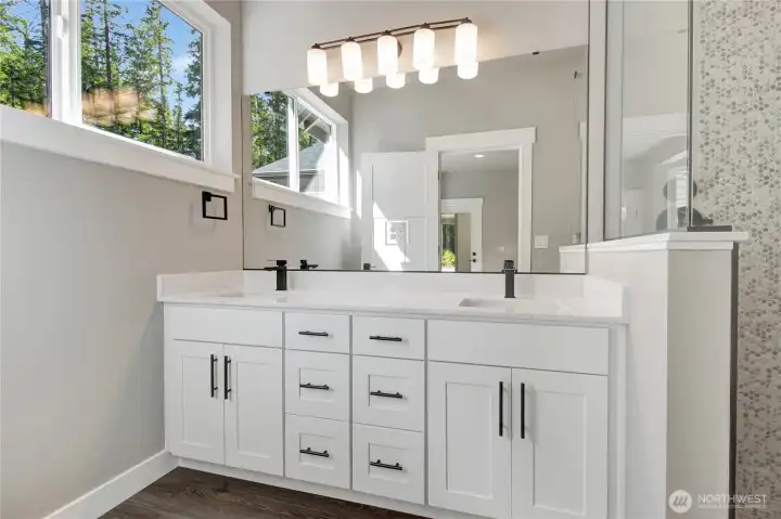 Primary bathroom with double sink vanity and quality tile work! Full surround glass shower included! A life of luxury!