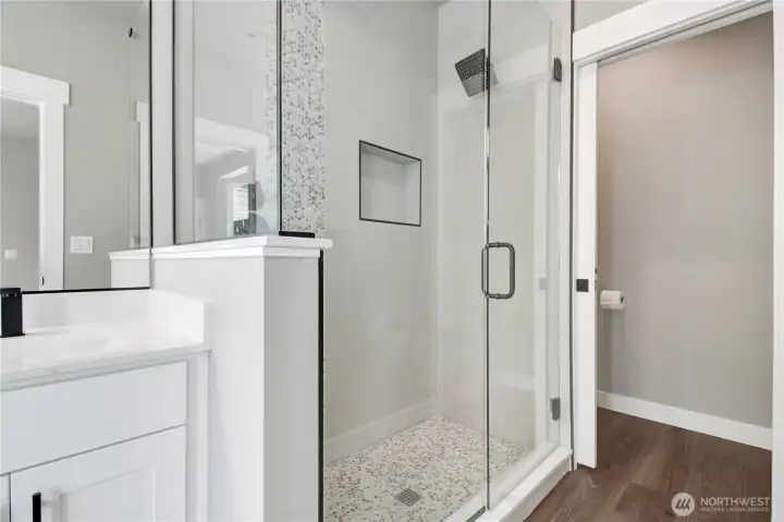 Primary suit fully tiled shower with glass surround and private throne room. All must haves for a home of this caliber.