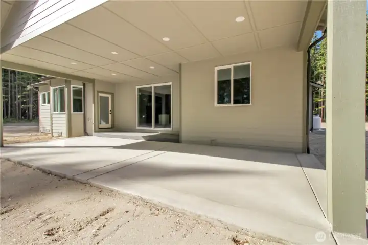 Huge back patio! never replace, never hurt it! always looks great and could easily be stained dark or neutral for a fun added accent. Prone hookup also included.
