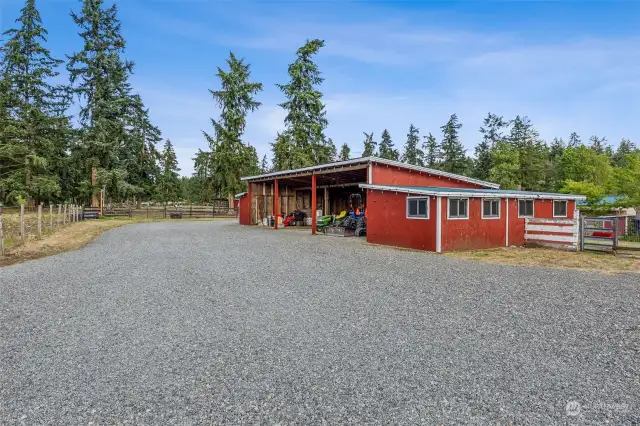 The covered parking portion of this outbuilding is 44'x27'. There is a barn enclosure at each end, measuring roughly 12'x27'. Please see the attached listing supplements and/or 3D tour for additional details and photos.