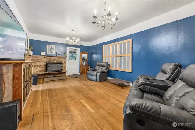 Living room with woodstove to heat the house and keep you cozy this winter. The door seen here leads to the covered porch.