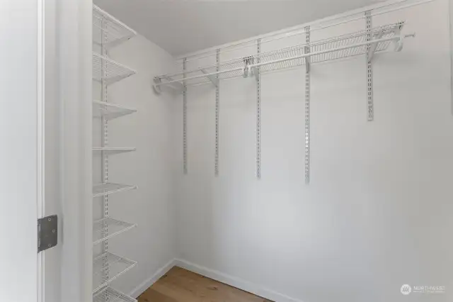 Super sized walk in closet with built in shelving system.