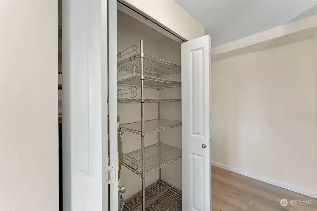 Pantry closet & water heater adjacent to the kitchen