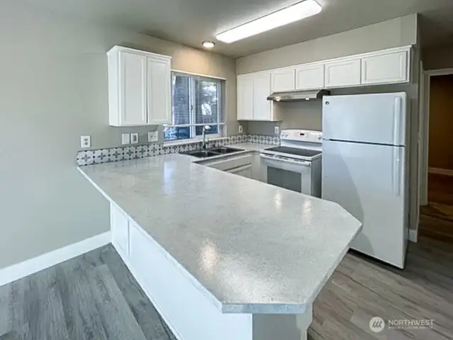 Unit A kitchen with breakfast bar.