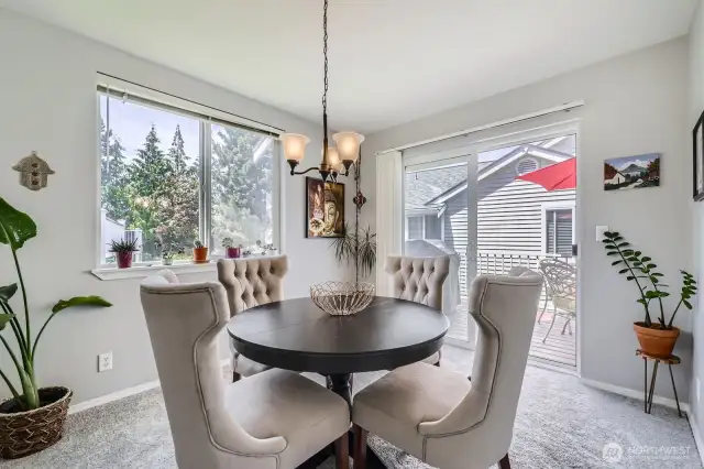 The spacious dining room leads to the deck through the sliding glass doors.